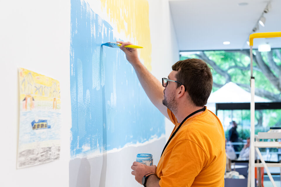 Artist Martin Edge installing his mural in the Queensland Art Gallery cafe, Brisbane, 2020. Photography: Chloë Callistemon, QAGOMA.